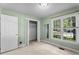 Bright bedroom featuring a window, a door, and a closet for ample space at 140 Heatherwood Dr, Apex, NC 27502
