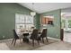 Elegant dining room with modern chandelier and views to the kitchen through a passthrough at 140 Heatherwood Dr, Apex, NC 27502
