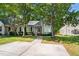 Charming home with mature trees, a bay window, and an inviting walkway at 140 Heatherwood Dr, Apex, NC 27502