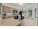 Well-lit kitchen with painted cabinets, modern appliances, and bright breakfast nook at 140 Heatherwood Dr, Apex, NC 27502