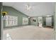 Bright living room featuring vaulted ceilings, a fireplace, and large windows at 140 Heatherwood Dr, Apex, NC 27502