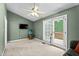 The living room has a sliding glass door to a wooden porch, fish tank and TV at 140 Heatherwood Dr, Apex, NC 27502