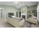 Staged living room featuring a fireplace, a ceiling fan, and neutral decor at 140 Heatherwood Dr, Apex, NC 27502