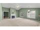 Spacious living room featuring vaulted ceilings, a fireplace, and large windows at 140 Heatherwood Dr, Apex, NC 27502