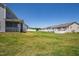 Green backyard featuring white fencing and beautiful neighborhood views at 147 Antler Steel Dr, Clayton, NC 27527