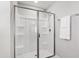 Modern bathroom featuring a stand-up shower with glass doors and white walls at 147 Antler Steel Dr, Clayton, NC 27527