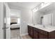 Bathroom featuring double sinks, modern fixtures, and a view into the bedroom at 147 Antler Steel Dr, Clayton, NC 27527