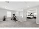 Bonus room area featuring neutral carpet and an abundance of natural light, exercise equipment, and a view to the bedroom at 147 Antler Steel Dr, Clayton, NC 27527