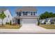Charming two-story home with a two-car garage, a concrete driveway and manicured front lawn at 147 Antler Steel Dr, Clayton, NC 27527