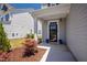 Inviting front porch with manicured landscaping, stylish door, and welcoming curb appeal at 147 Antler Steel Dr, Clayton, NC 27527