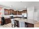 Granite counters, modern appliances, and dark wood cabinets highlight this stylish kitchen with an island and seating at 147 Antler Steel Dr, Clayton, NC 27527
