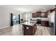 Modern kitchen with stainless steel appliances, granite counters, and dark wood cabinetry offers a stylish design at 147 Antler Steel Dr, Clayton, NC 27527
