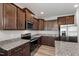 Well-appointed kitchen featuring granite countertops, modern appliances, and dark wood cabinetry for a sleek, stylish look at 147 Antler Steel Dr, Clayton, NC 27527