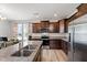 Modern kitchen featuring granite countertops, stainless steel appliances, and dark wood cabinetry in a spacious open layout at 147 Antler Steel Dr, Clayton, NC 27527