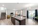 Bright open-concept kitchen featuring a granite island, stainless steel appliances, and modern finishes at 147 Antler Steel Dr, Clayton, NC 27527