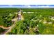 Aerial view showcases home in wooded neighborhood with nearby roadways at 1609 Falls Ct, Raleigh, NC 27615