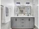 Modern bathroom featuring a double vanity, sleek mirrors, and a stylish design with a glass shower at 1609 Falls Ct, Raleigh, NC 27615