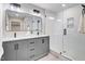 Sleek bathroom boasts a double vanity, modern mirrors, and a glass-enclosed shower for a spa-like experience at 1609 Falls Ct, Raleigh, NC 27615
