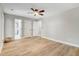 Large, light-filled bedroom with wood-look flooring, ceiling fan, and doors to bathroom and closet at 1609 Falls Ct, Raleigh, NC 27615
