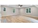 Spacious room with plenty of natural light, light colored floors, and a modern ceiling fan at 1609 Falls Ct, Raleigh, NC 27615