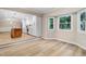 Bright dining area featuring hardwood floors, large windows, and an open view into the kitchen at 1609 Falls Ct, Raleigh, NC 27615