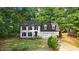 Charming two-story home with black shutters, dormers, well-manicured lawn, and attached two car garage at 1609 Falls Ct, Raleigh, NC 27615