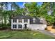 Charming two-story home with black shutters, dormers, well-manicured lawn, and attached two car garage at 1609 Falls Ct, Raleigh, NC 27615