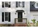 Close up of front door with a small porch and updated front door with sidelights at 1609 Falls Ct, Raleigh, NC 27615