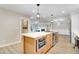 Kitchen island with built in oven range and view of a living room at 1609 Falls Ct, Raleigh, NC 27615