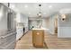 Modern kitchen with stainless steel appliances and a large island with quartz countertops at 1609 Falls Ct, Raleigh, NC 27615