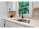 Modern kitchen sink with a black faucet, wood cutting board, and stainless-steel fixtures at 1609 Falls Ct, Raleigh, NC 27615