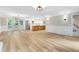 Open-concept living room and kitchen with hardwood floors and French doors to the outside at 1609 Falls Ct, Raleigh, NC 27615
