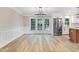 Bright living room with hardwood floors, crown molding, and French doors to the outside at 1609 Falls Ct, Raleigh, NC 27615