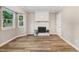 Bright living room with brick fireplace, natural light, and hardwood floors at 1609 Falls Ct, Raleigh, NC 27615