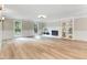 Bright and spacious living room featuring a fireplace, open floor plan, and hardwood floors at 1609 Falls Ct, Raleigh, NC 27615