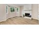 Living room with brick fireplace, natural light and bay windows at 1609 Falls Ct, Raleigh, NC 27615