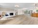 Bright and spacious living room featuring a fireplace, open floor plan, and hardwood floors at 1609 Falls Ct, Raleigh, NC 27615