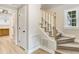 Stairway with light wood steps and white risers leading to the upper level of the home at 1609 Falls Ct, Raleigh, NC 27615