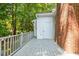 Exterior back deck view, with gray wood planks and white siding at 1623 Village Glenn Dr, Raleigh, NC 27612