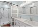 Modern bathroom featuring double sinks, a sliding barn door, and a glass-enclosed shower at 1623 Village Glenn Dr, Raleigh, NC 27612