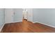 This bedroom features hardwood floors, a neutral color scheme, and access to the bathroom at 1623 Village Glenn Dr, Raleigh, NC 27612