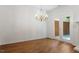 Light-filled dining room with hardwood floors, chandelier, and glass doors leading to the patio at 1623 Village Glenn Dr, Raleigh, NC 27612