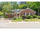 Charming one-story brick home with dormer windows, black shutters, and a nicely landscaped front yard at 1623 Village Glenn Dr, Raleigh, NC 27612