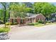 Quaint single story brick home with black shutters and landscaped yard at 1623 Village Glenn Dr, Raleigh, NC 27612