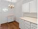 Bright kitchen with modern appliances, white cabinets, and hardwood flooring at 1623 Village Glenn Dr, Raleigh, NC 27612