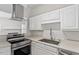 Modern kitchen with stainless steel appliances and white cabinets at 1623 Village Glenn Dr, Raleigh, NC 27612