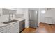 Bright kitchen area with stainless steel appliances and light-colored cabinets at 1623 Village Glenn Dr, Raleigh, NC 27612