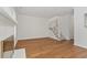 Bright living room features a fireplace, hardwood floors, and a staircase with white railing at 1623 Village Glenn Dr, Raleigh, NC 27612