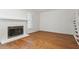 Bright living room features a fireplace, hardwood floors, and a staircase with white railing at 1623 Village Glenn Dr, Raleigh, NC 27612
