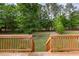 Wood deck overlooking backyard with lush green trees and a serene setting at 168 Hoss Ridge Ln, Dunn, NC 28334